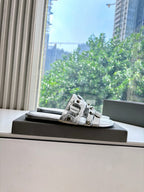 Balenciaga silver slide sandal with metallic buckle straps on display box