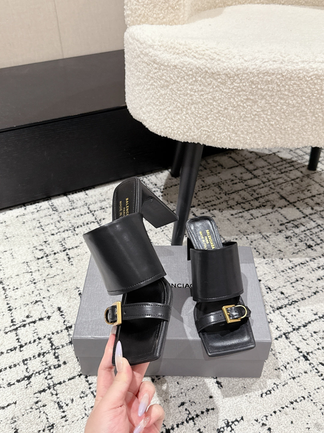 Black leather slide sandals with gold-tone buckle detail and stacked block heel