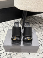 Black leather slide sandals with wide straps and gold buckle, block heel