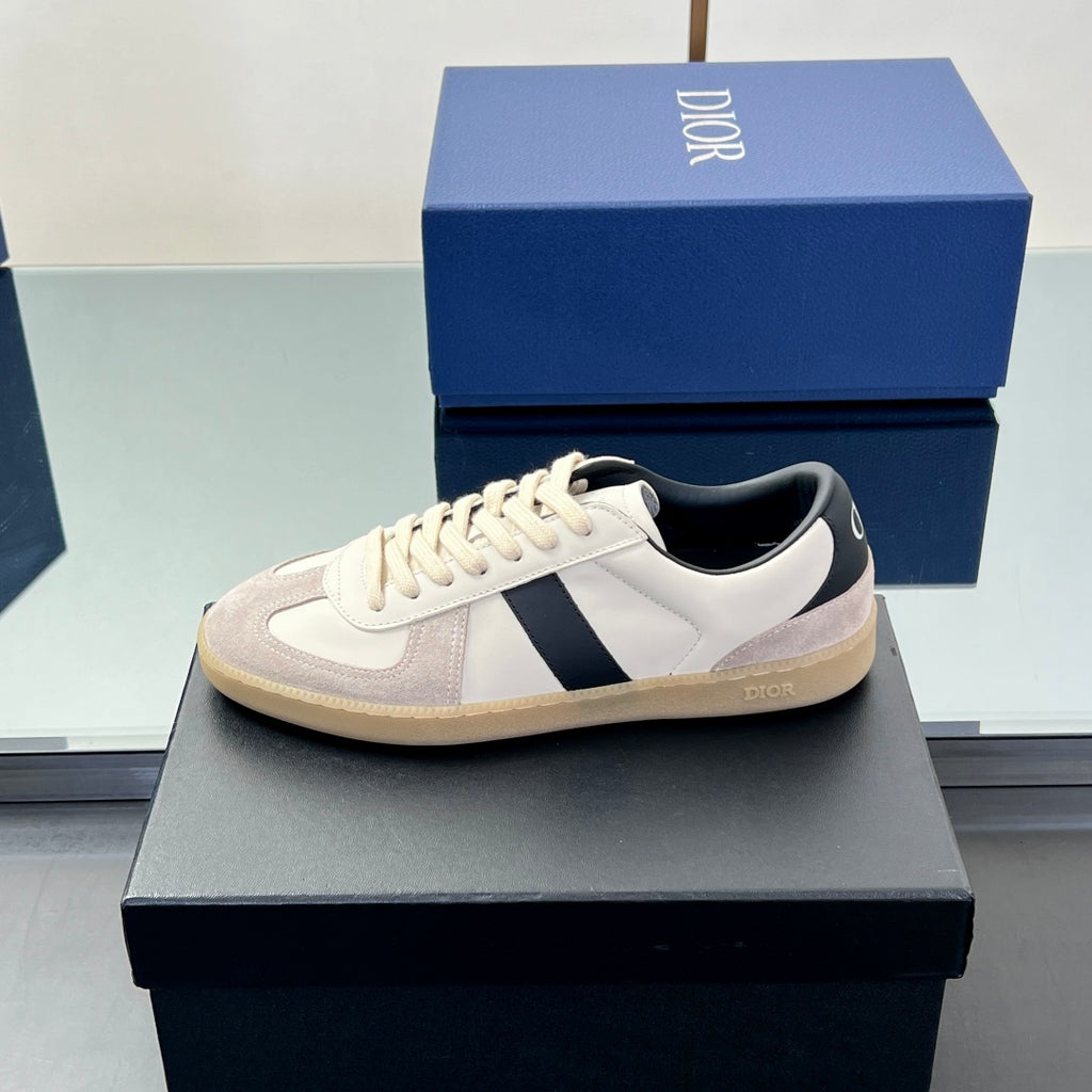 Low-top sneaker with white upper, navy stripe, and beige gum-style outsole