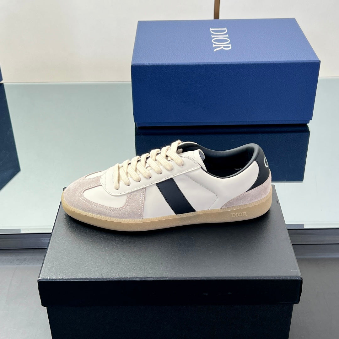 Low-top sneaker with white upper, navy stripe, and beige gum-style outsole