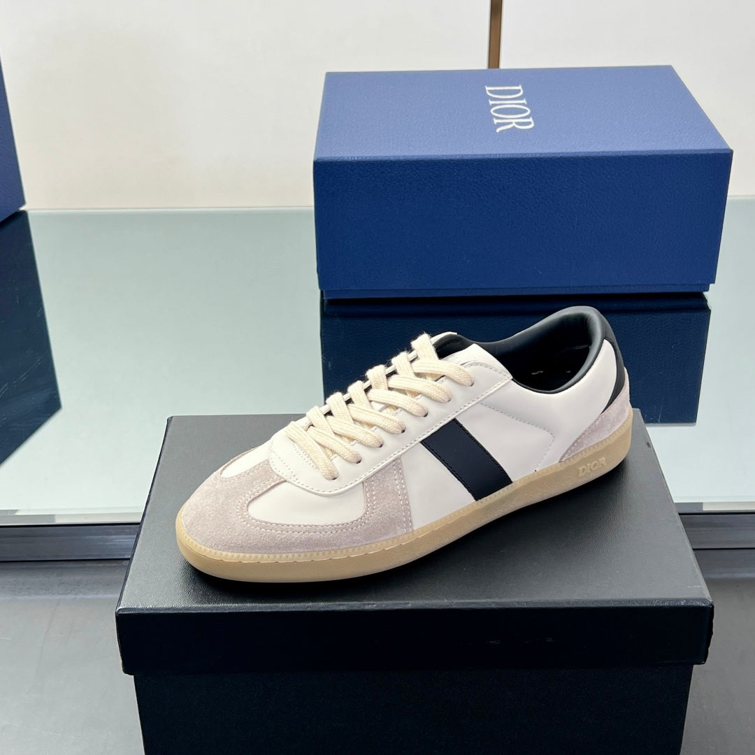 White and beige low-top sneakers with navy side stripe and lace-up front
