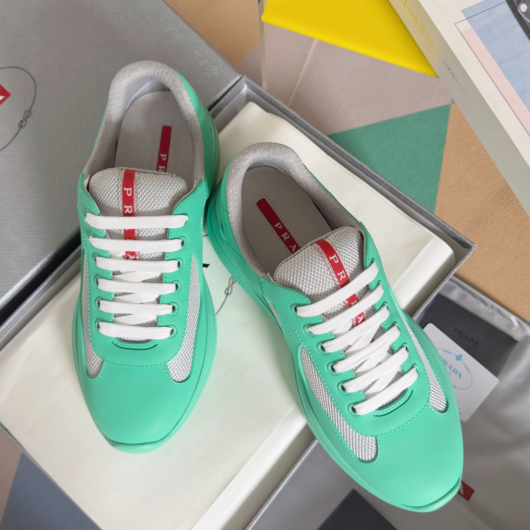 Prada unisex low-top sneakers in mint green with white laces and gray mesh panels