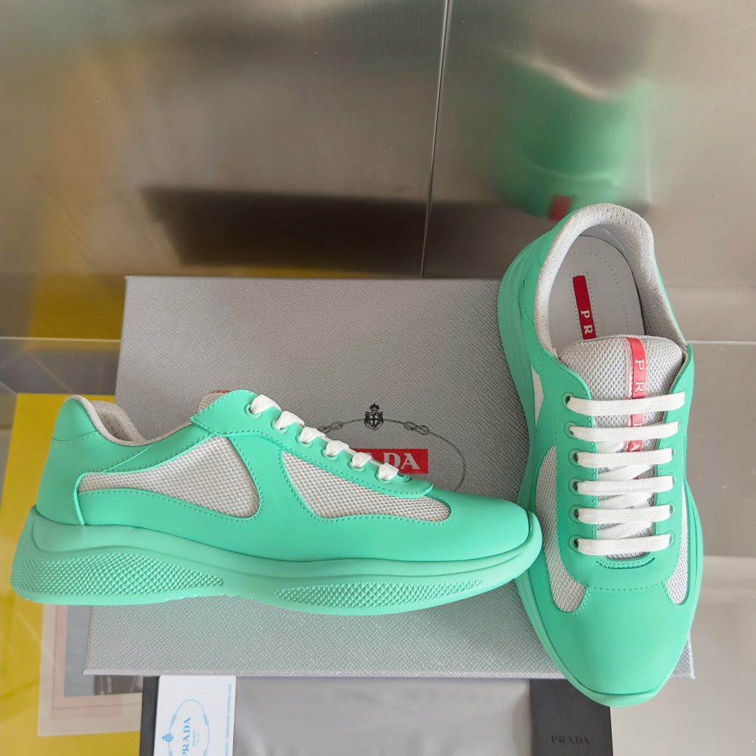Prada unisex sneakers on a box, mint green with white laces and gray side panels