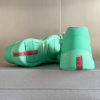 Prada unisex mint green sneakers heel view with red Prada label and textured sole