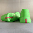Prada unisex sneakers outsole view, neon green with red logo label at heel