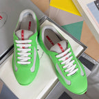 Prada unisex sneakers in neon green with gray suede panels and white lace-up front