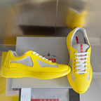 Yellow low-top sneakers with white swoosh, lace-up front and textured sole