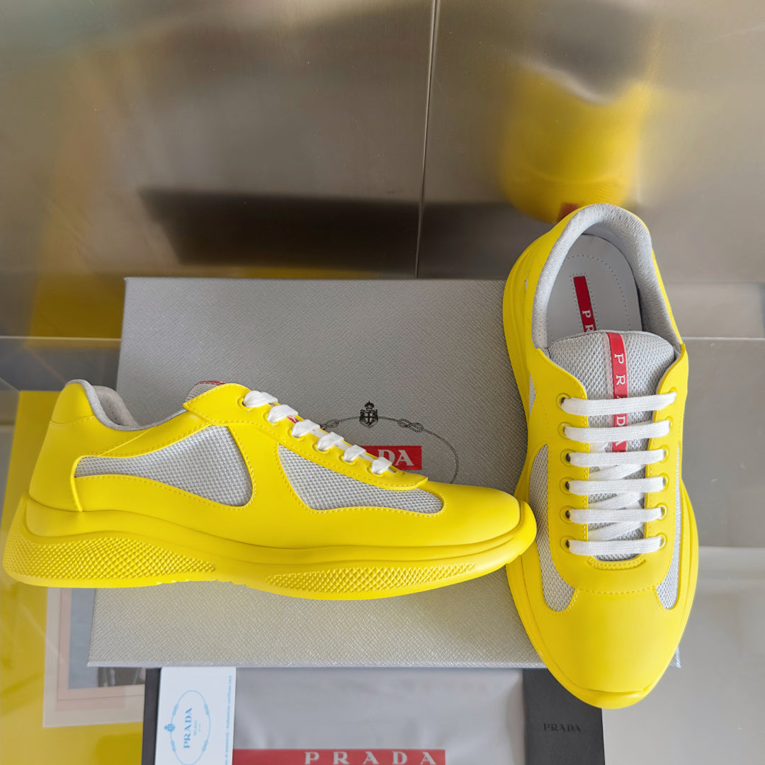 Yellow low-top sneakers with white swoosh, lace-up front and textured sole