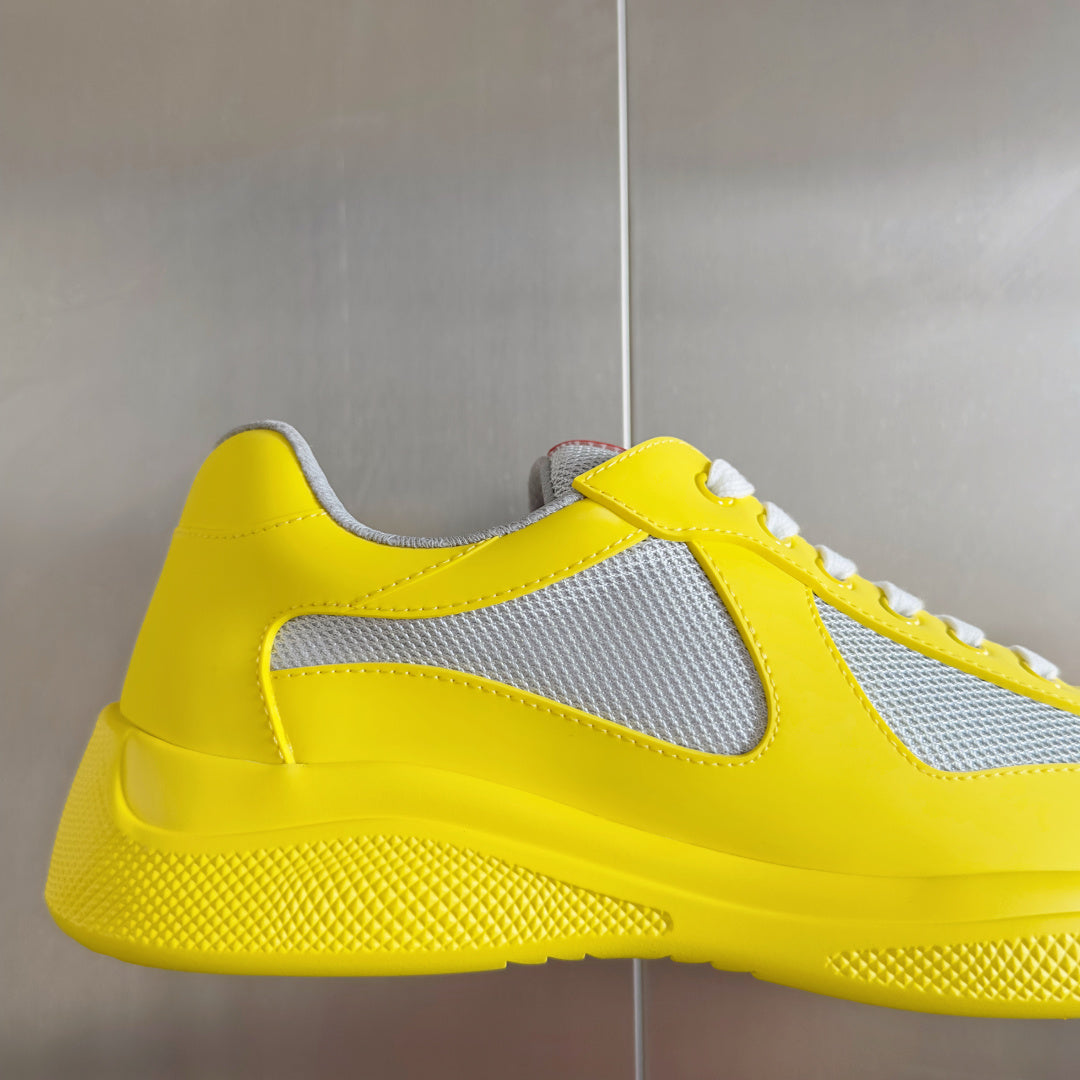 Yellow low-top sneaker with white swoosh detail and textured midsole