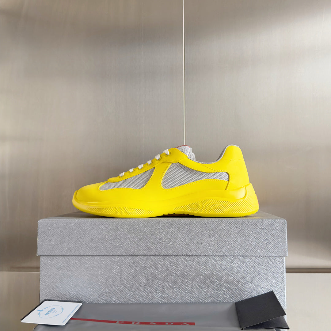 Yellow low-top sneakers with white mesh upper and lace-up front