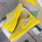 Yellow low-top sneakers with white mesh side panels and lace-up front