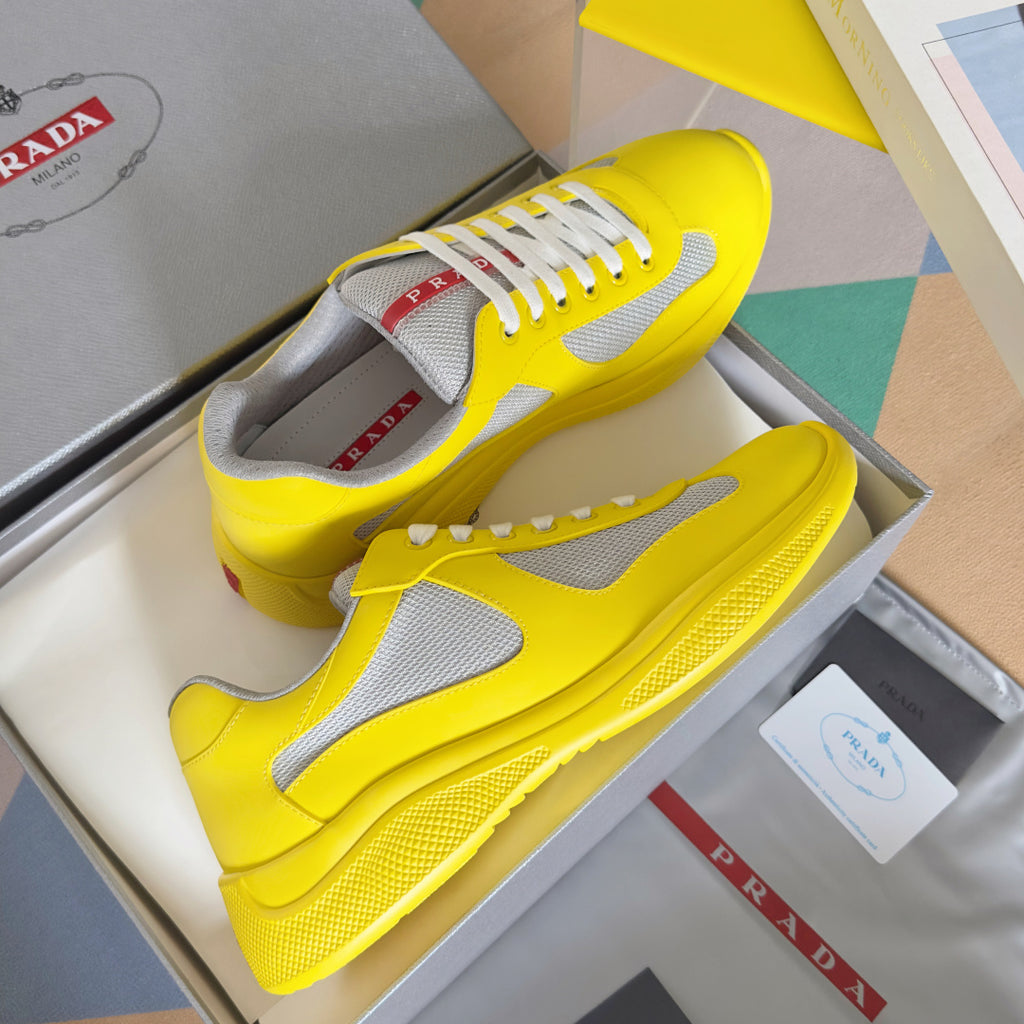 Yellow low-top sneakers with white side panel and lace-up closure