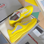 Yellow low-top sneakers with white side panel and lace-up closure