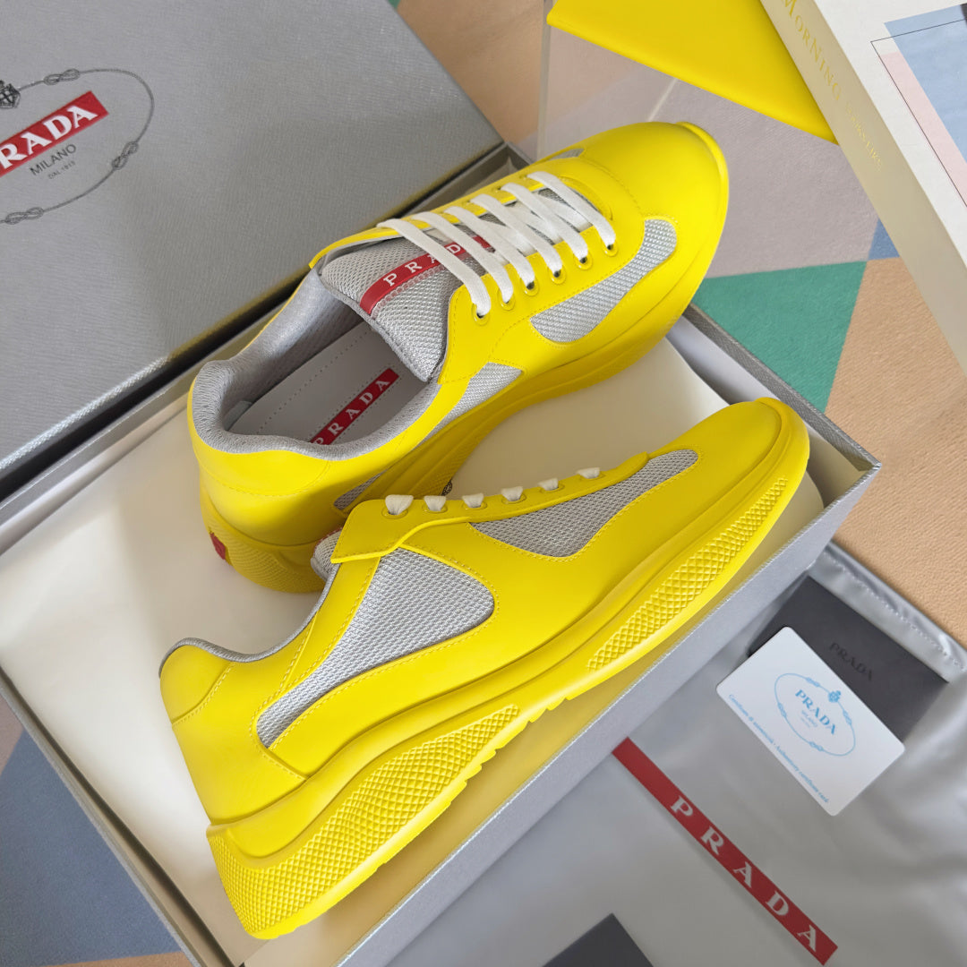 Yellow low-top sneakers with white side panel and lace-up closure