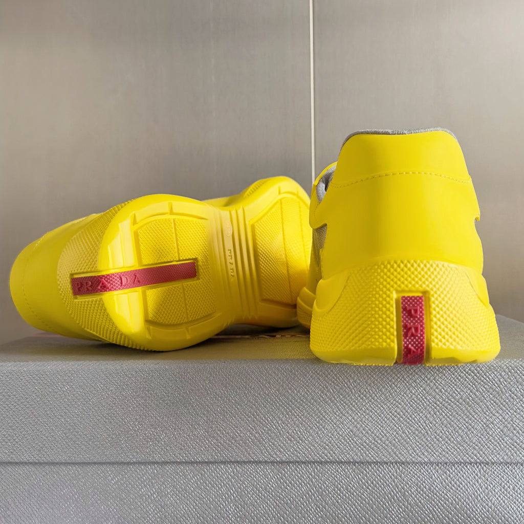 Yellow low-top sneakers with textured outsole and logo heel tag