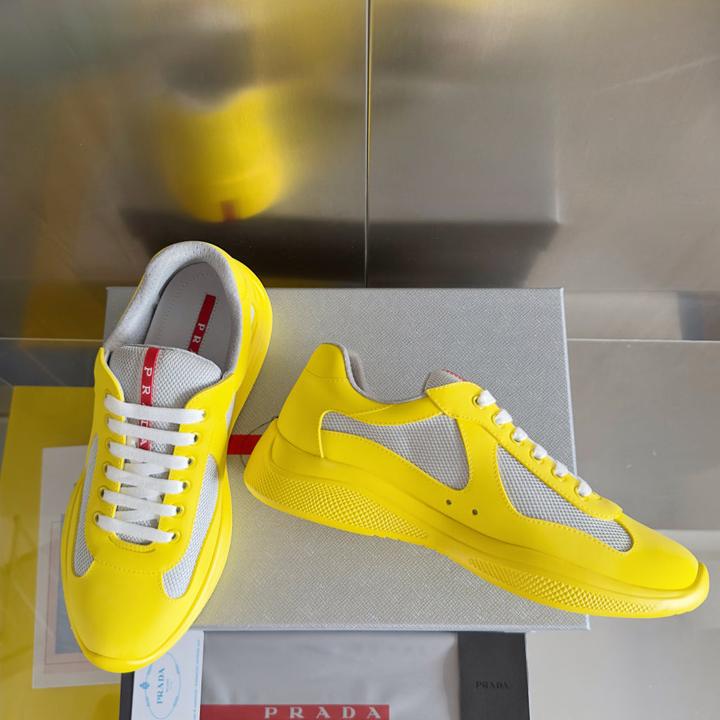 Yellow low-top sneakers with white mesh upper, lace-up style and chunky sole