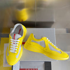 Yellow low-top sneakers with white mesh upper, lace-up style and chunky sole