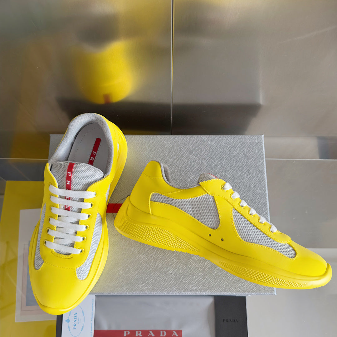 Yellow low-top sneakers with white mesh upper, lace-up style and chunky sole