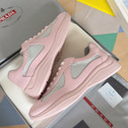 Pair of pink Prada unisex sneakers with gray mesh uppers and cushioned sole