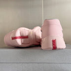 Pink Prada unisex sneakers, heel and side view with white laces and red logo tag