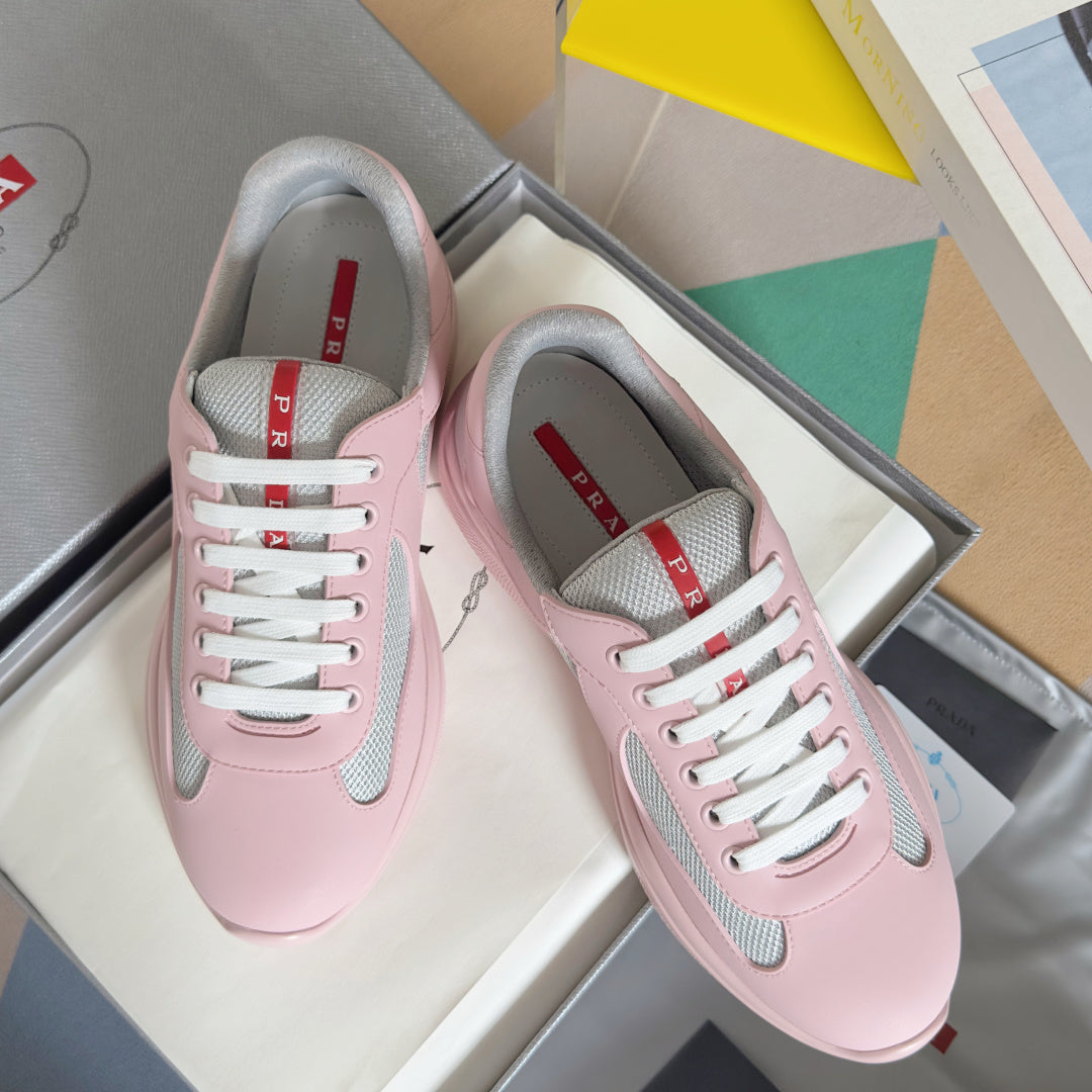 Pink Prada unisex sneakers with white laces and gray mesh side panels