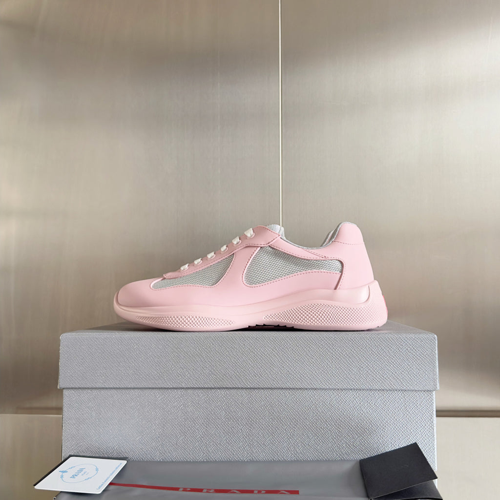Pink Prada unisex sneakers on a box, low-cut design with gray mesh accents
