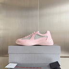 Pink Prada unisex sneakers on a box, low-cut design with gray mesh accents