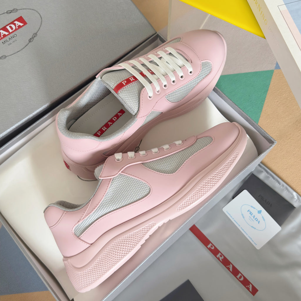 Pink Prada unisex low-top sneakers with gray mesh panels and white lace-up style