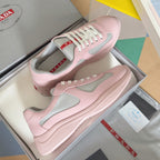 Pink Prada unisex low-top sneakers with gray mesh panels and white lace-up style