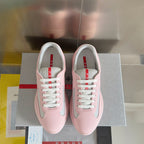 Pink Prada unisex sneakers, front view, white laces and gray mesh side insets