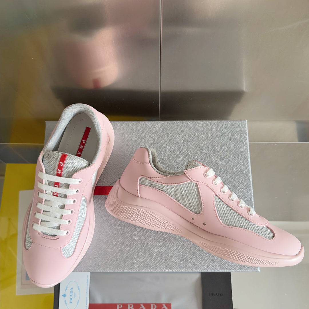 Pink Prada unisex sneakers, side and front view, gray mesh panels and white laces