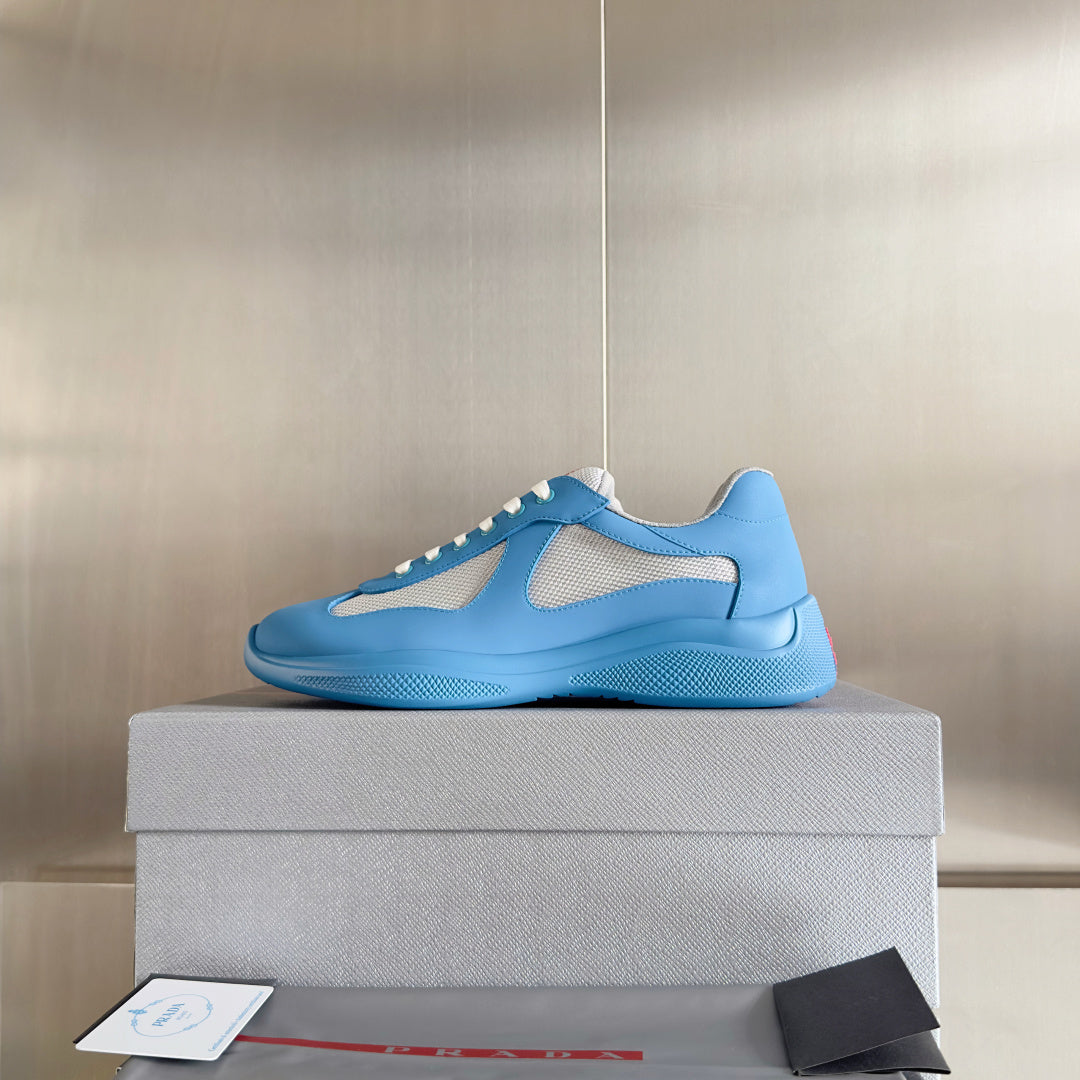Prada unisex sneakers in light blue with white lace trim and breathable mesh inserts
