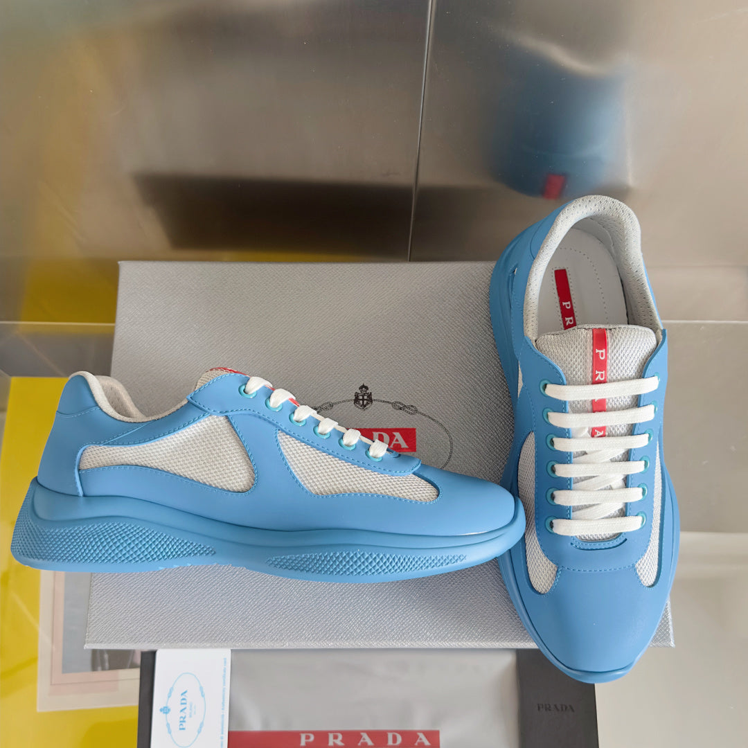 Prada unisex sneakers, light blue with white mesh panels and contrasting lace loops