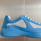 Prada unisex sneaker side view in light blue with white mesh panels