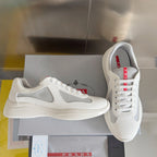 White Prada unisex low-top sneakers with gray swoosh-style panel, red logo details