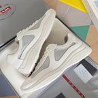 White Prada unisex lace-up sneakers with gray side panel and chunky sole