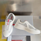 White Prada unisex sneakers on box, with gray panels and lace-up front