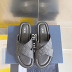 Dior slide sandals with gray monogram straps on dark cushioned footbeds