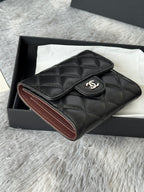 Small quilted leather flap bag, black exterior with brown interior trim and CHANEL CC.