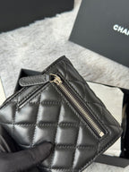 Black quilted small bag with top zipper and stitched diamond pattern