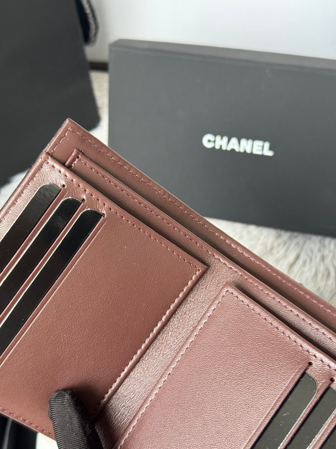 Small leather wallet-style bag, brown, close-up of card slots and inner compartments.