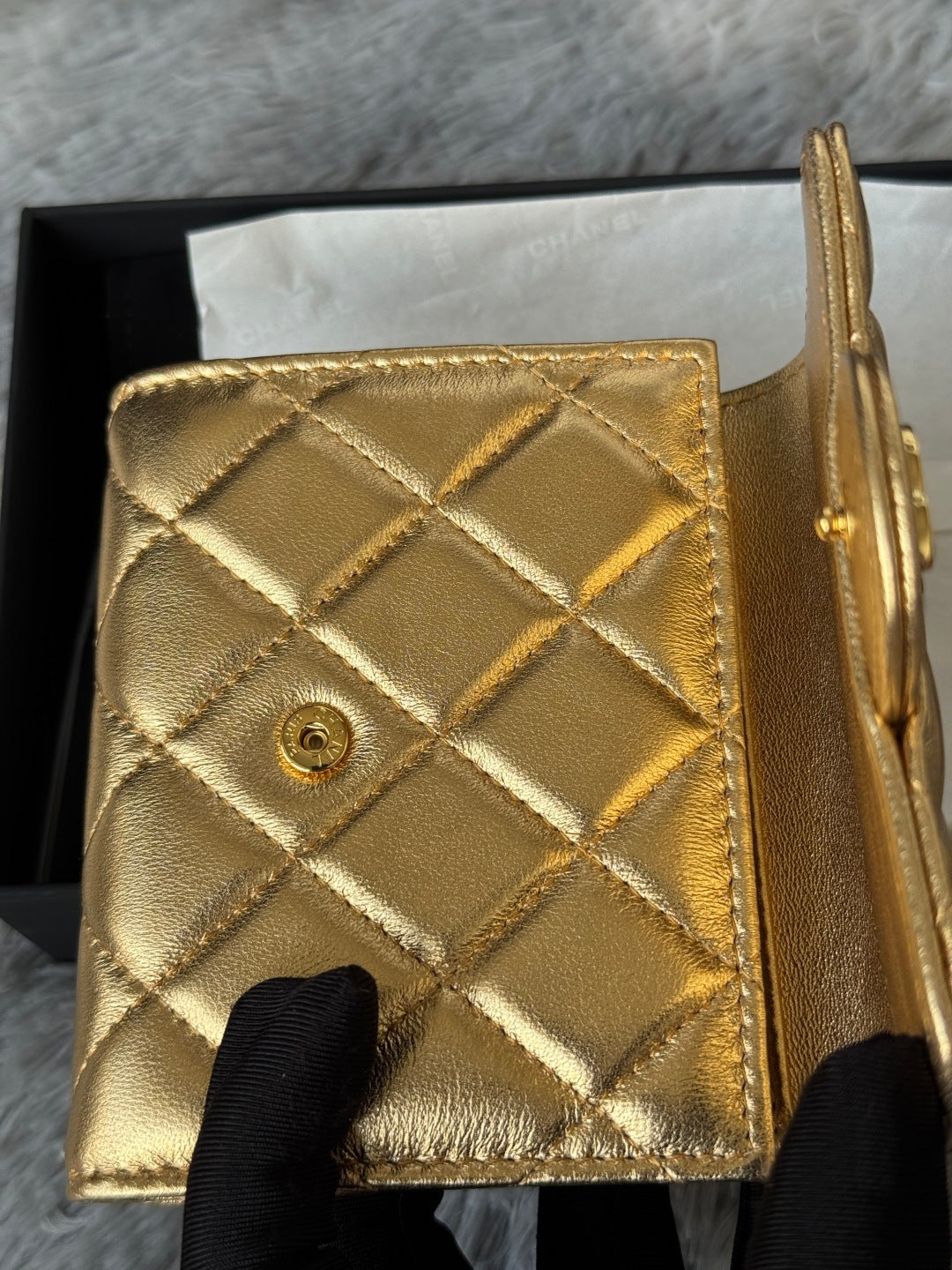 Chanel small gold quilted mini bag back view with diamond pattern and button detail