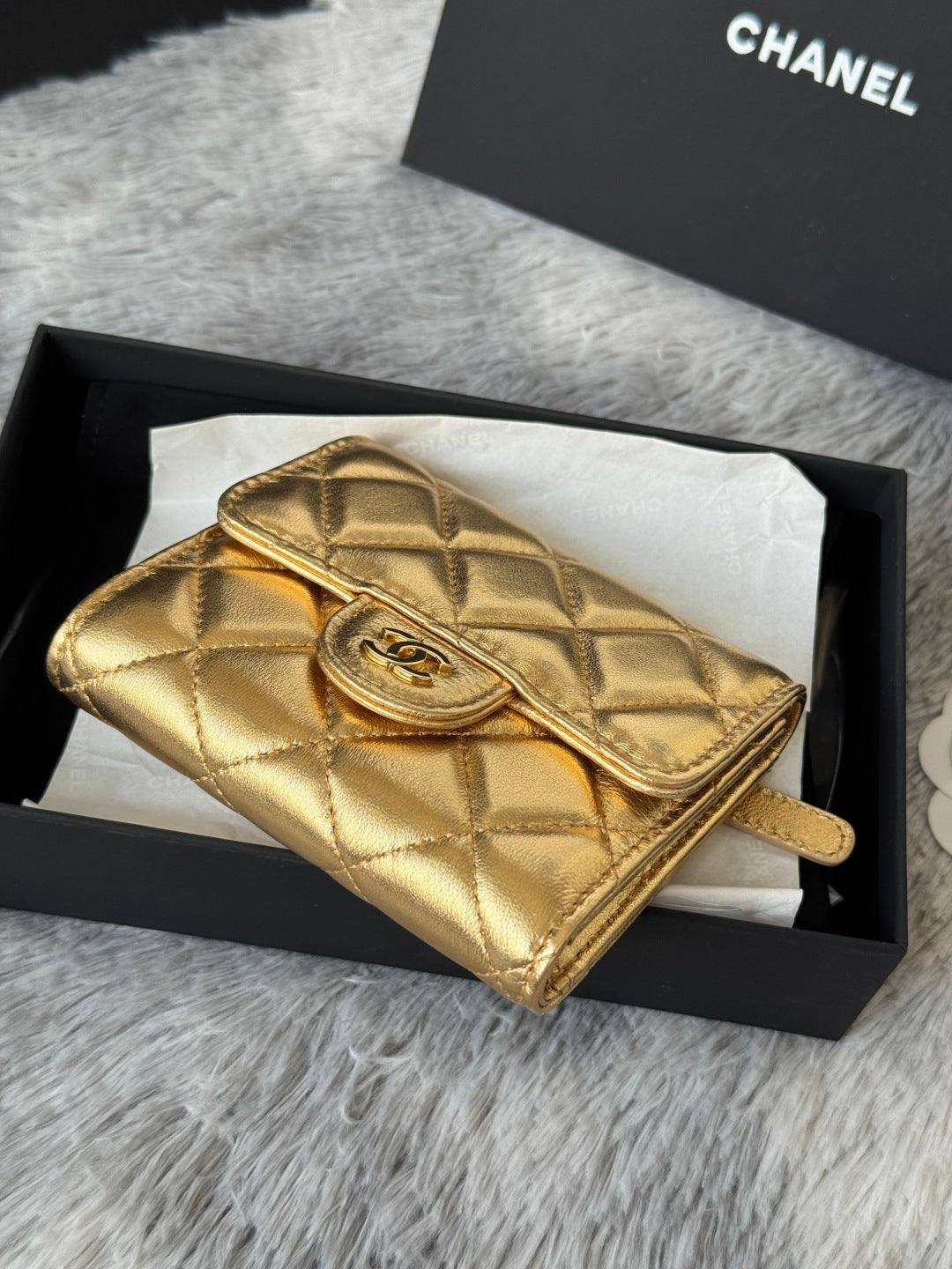 Chanel small gold quilted wallet-style mini bag with strap and front clasp