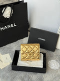 Chanel small gold quilted mini bag with flower detail and flap front in gift box