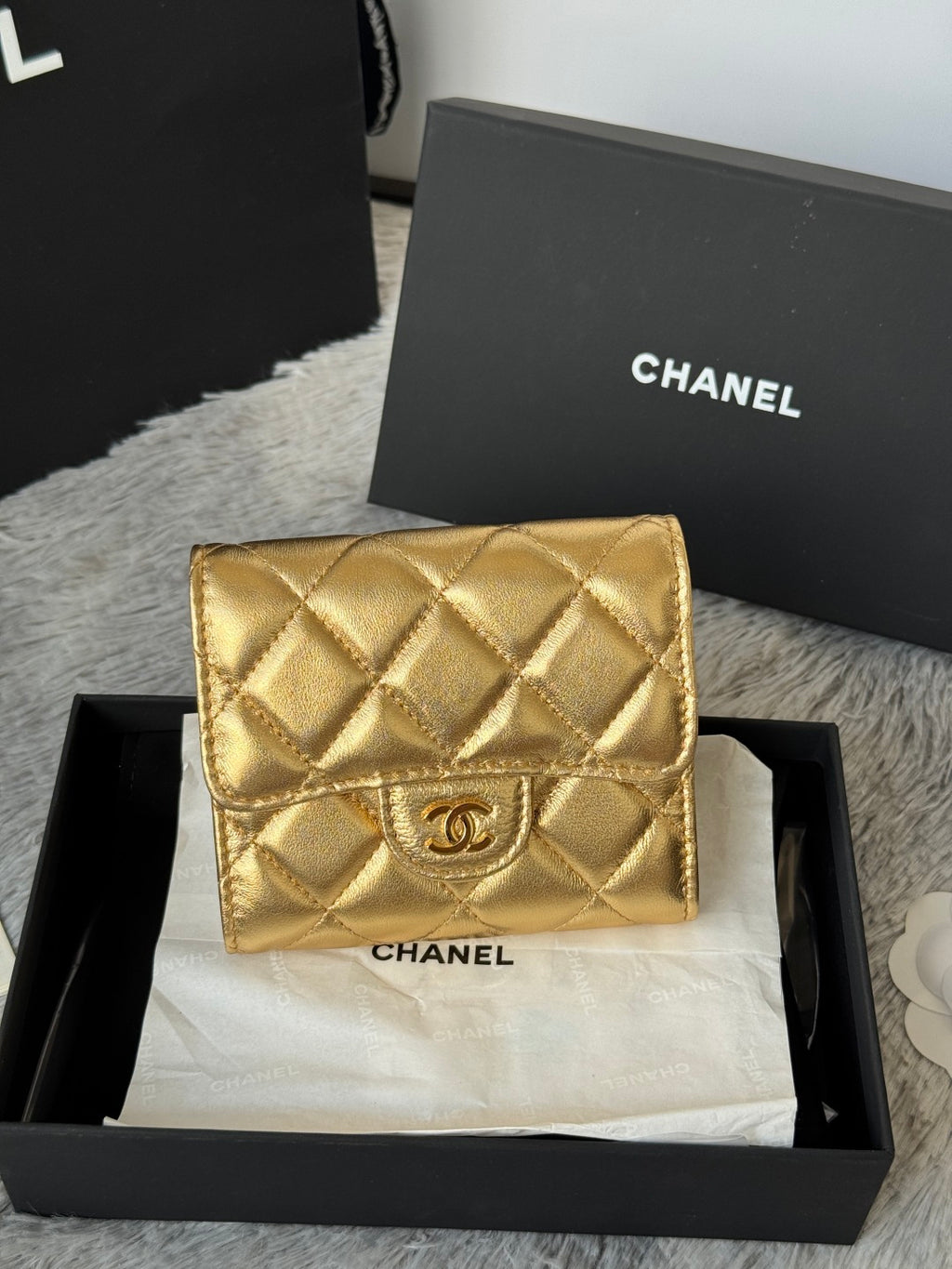Chanel small gold quilted mini flap bag with CC logo on front, in box