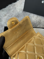 Gold small flap bag with snap button and quilted front panel