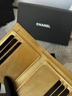 Chanel small gold mini bag interior card slots and stitching detail, close-up
