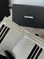 Chanel small silver bag interior card slots with stitched lining and zipper edge.