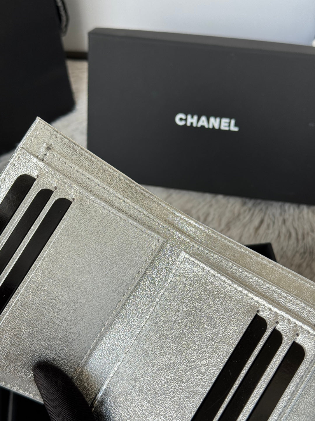 Chanel small silver bag interior card slots with stitched lining and zipper edge.